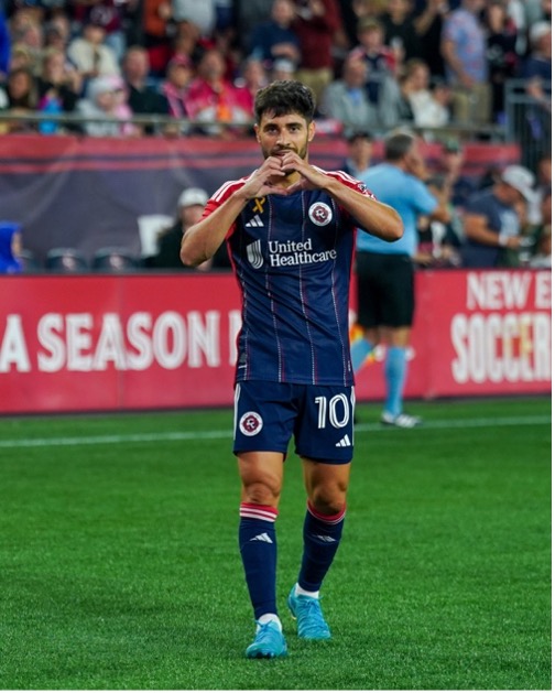 Professional soccer player makes heart gesture with his hands